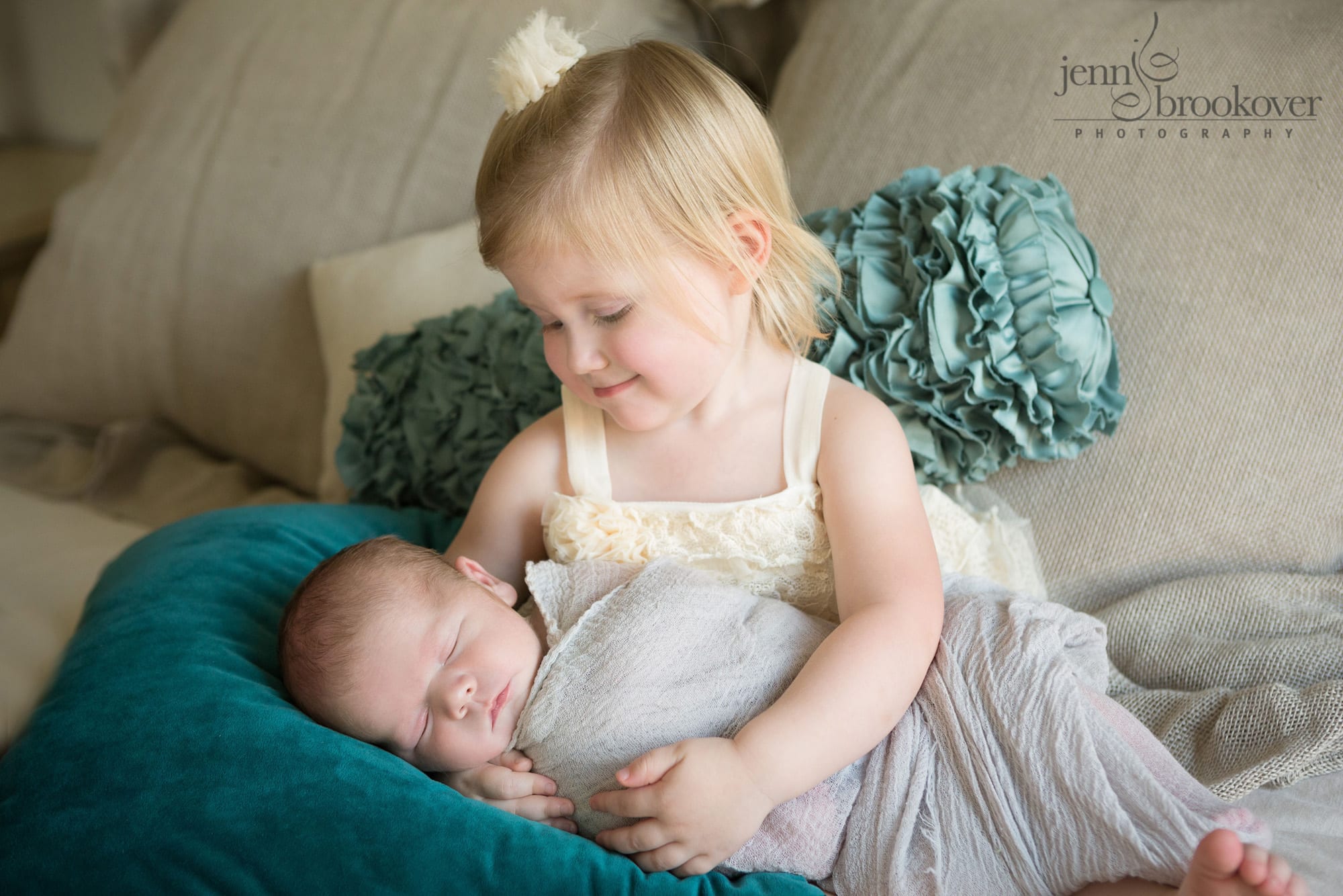 big sister smiling at newborn baby brother during lifestyle newborn session in San Antonio