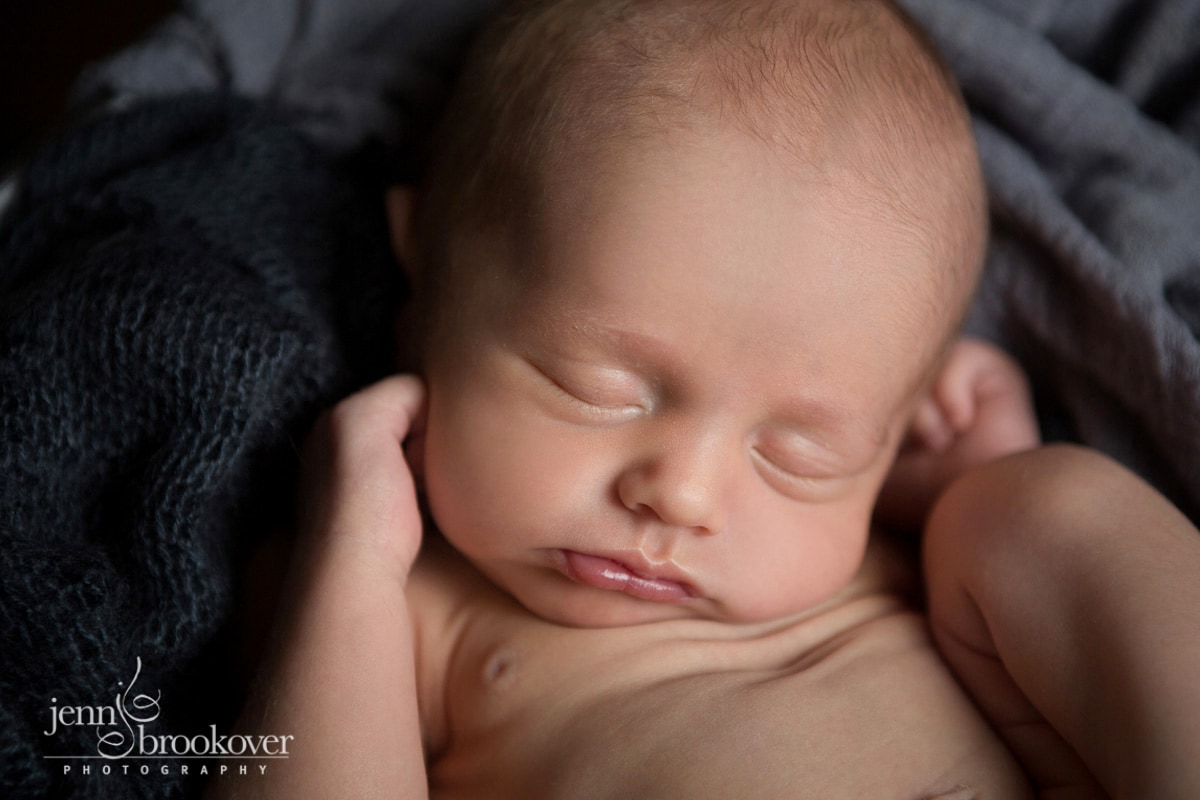 baby boy asleep on dark gray background during his newborn session with Jenn Brookover Photography in Alamo Heights