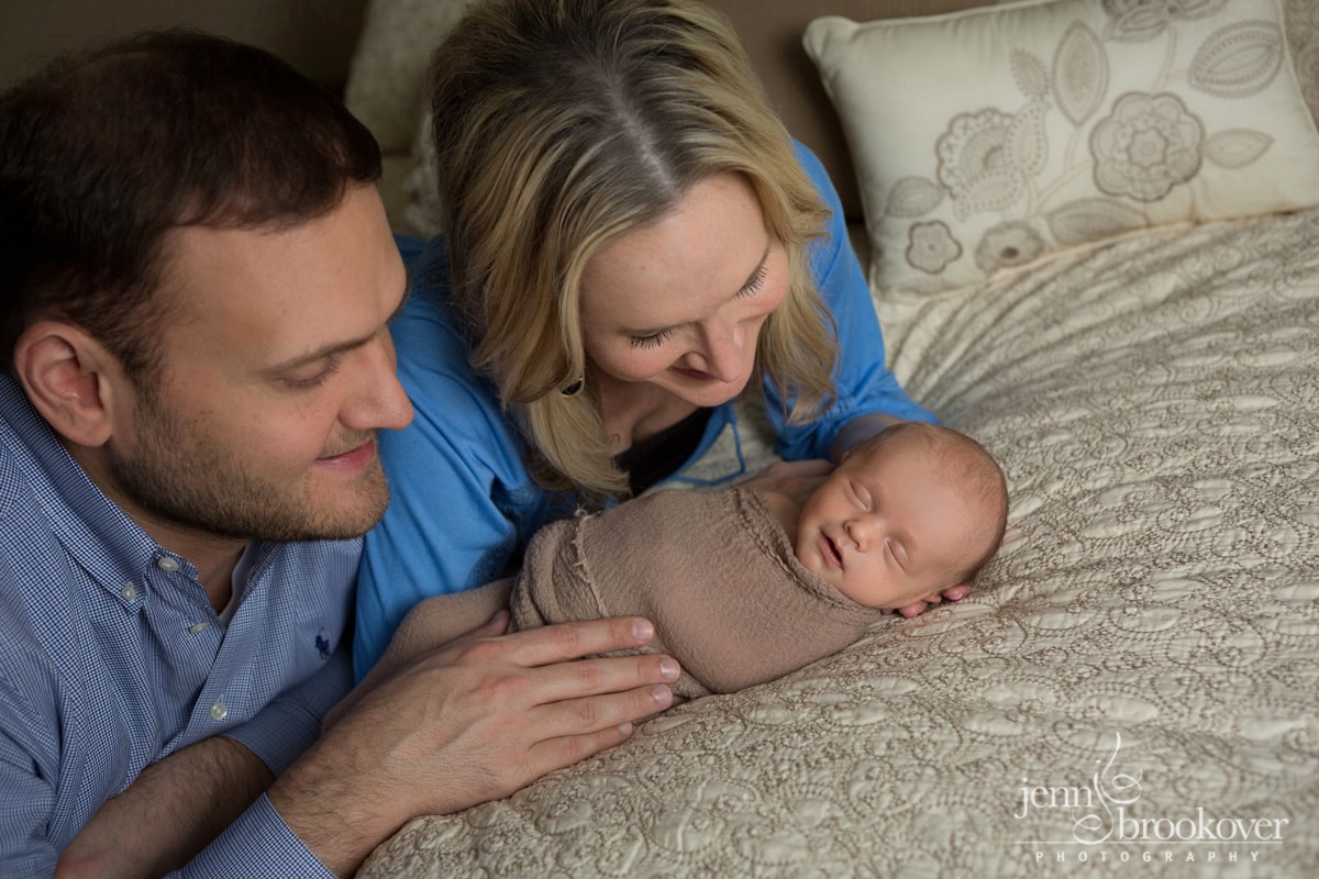 sweet family admiring their newborn baby boy at home in Alamo Heights Texas by Jenn Brookover
