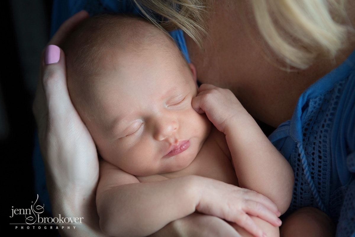 close up of baby boy during his newborn session while being held by mom in Alamo Heights Texas by Jenn Brookover
