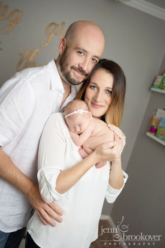 proud parents of new baby girl in her nursery at home in San Antonio by Jenn Brookover Photography