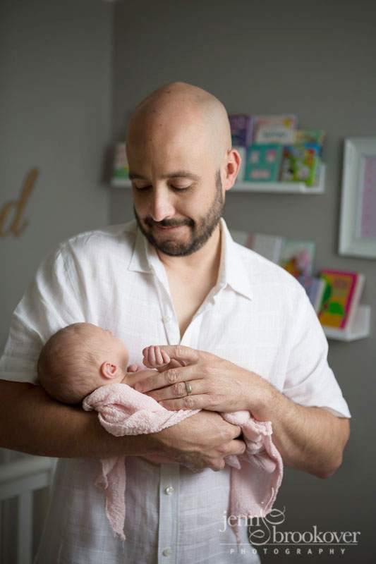 dad and baby girl cuddling during newborn photo session with Jenn Brookover in San Antonio
