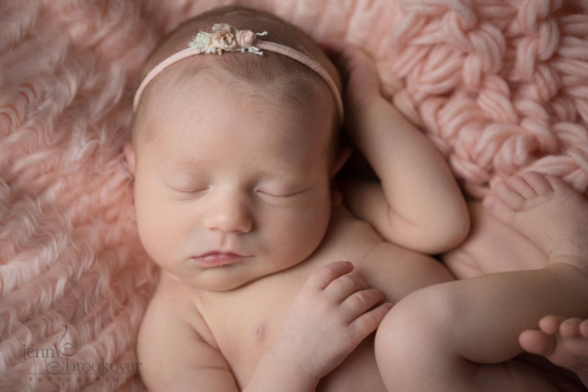baby girl on pink fur with headband by Devoted Knits taken by Jenn Brookover