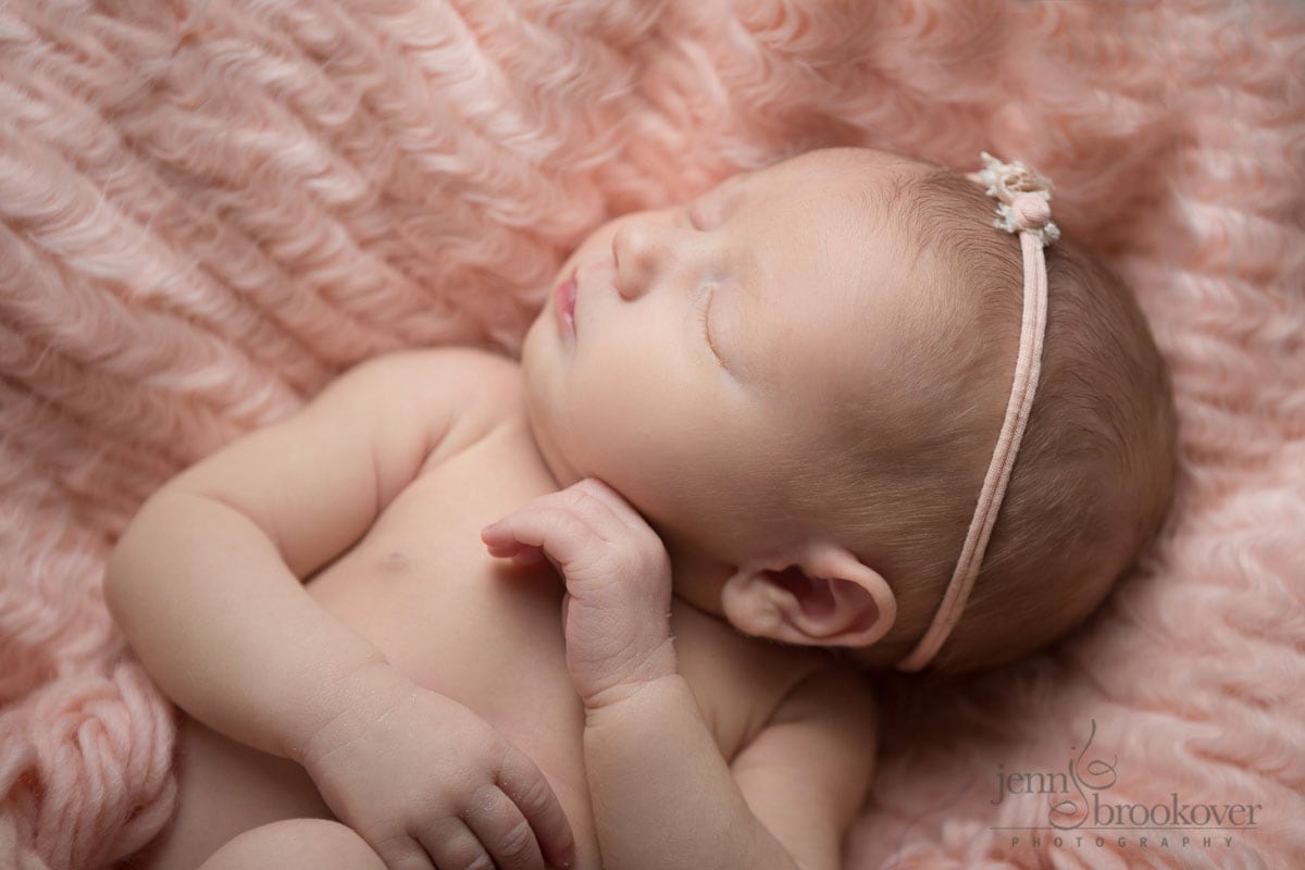 sweet baby cheeks and lips of baby girl taken by Jenn Brookover on pink fur