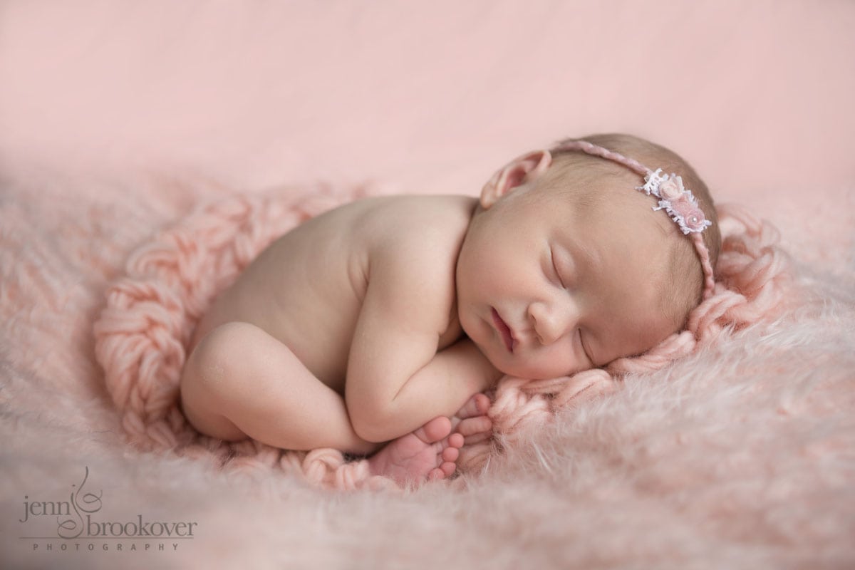 San Antonio newborn portrait of baby on pink blanket showing her little feet taken by Jenn Brookover