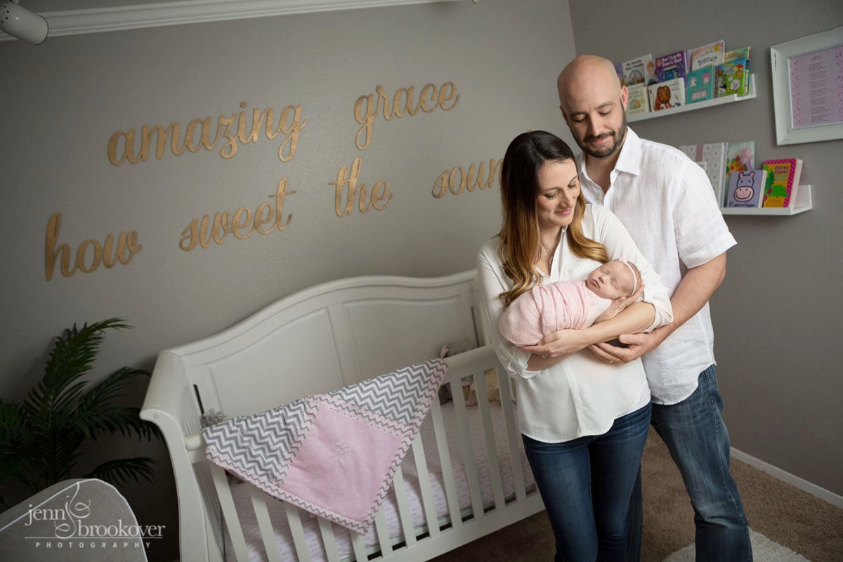 gorgeous newborn at home in San Antonio in her pink, gold and gray nursery with mom and dad by Jenn Brookover Photography
