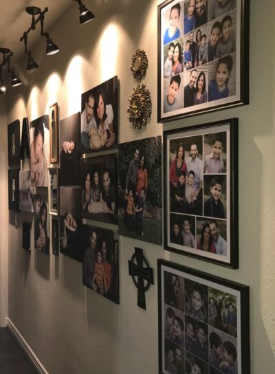 A hallway with many pictures hanging on the wall.