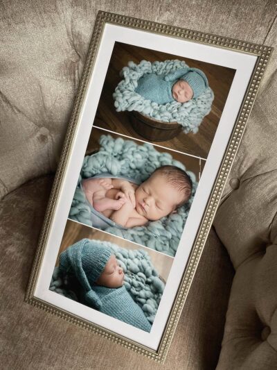 A framed photo of a newborn baby in a blue blanket.