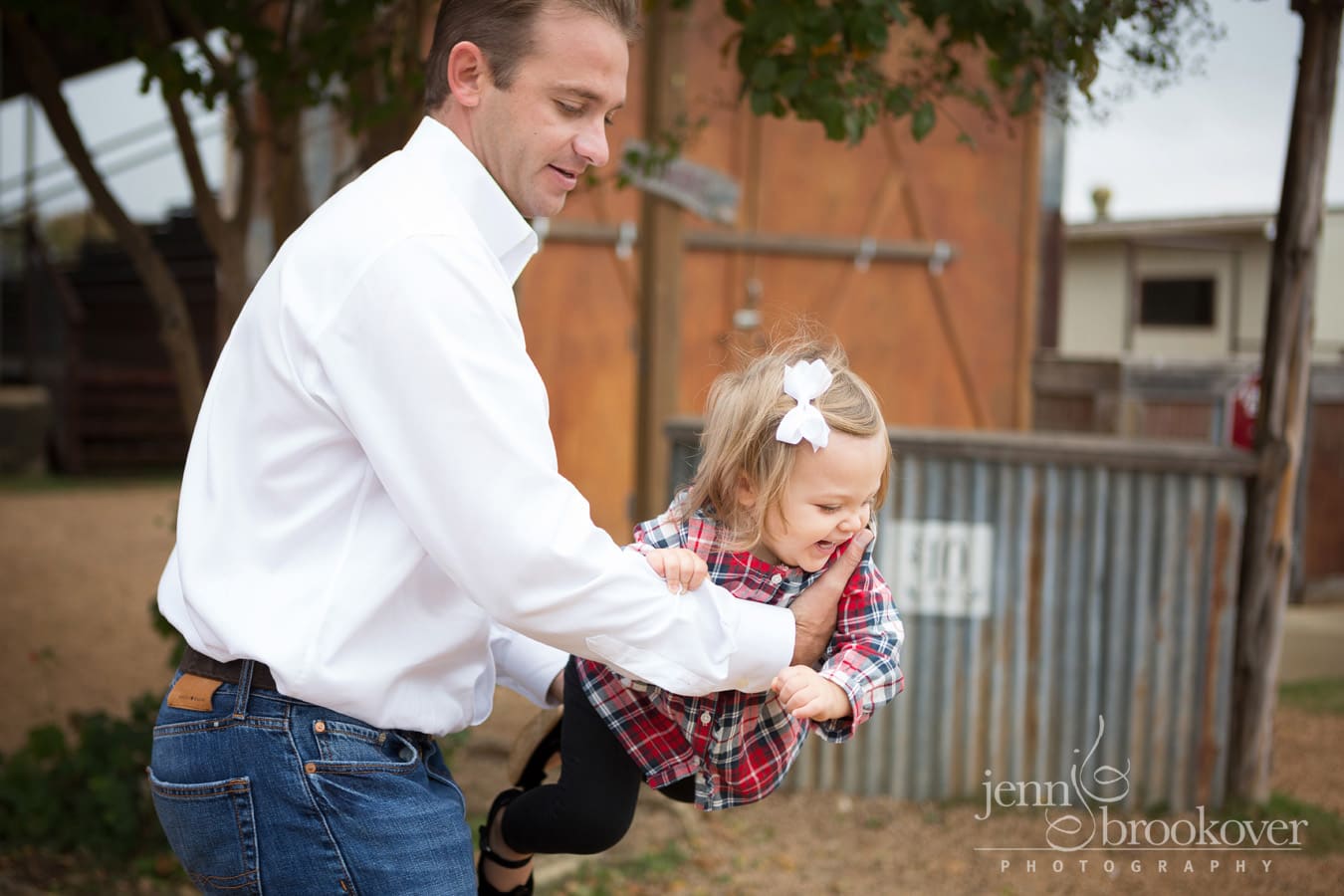 dad and daughter laughing and playing at Tejas Rodeo