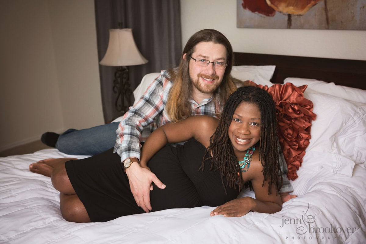 maternity portrait of mom and dad smiling at home in San Antonio Texas by Jenn Brookover
