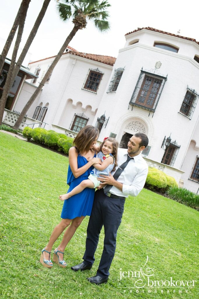 family laughing with daughter in front of the McNay Art Museum 