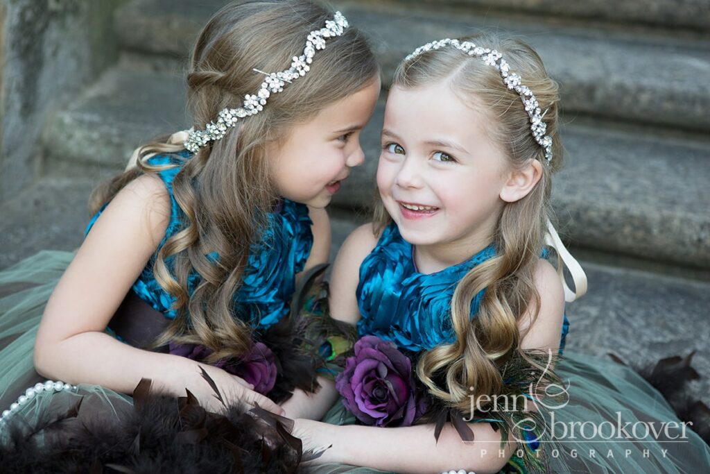 sisters giggling wearing crystal headbands dressed in purple and teal for their family portraits at McNay