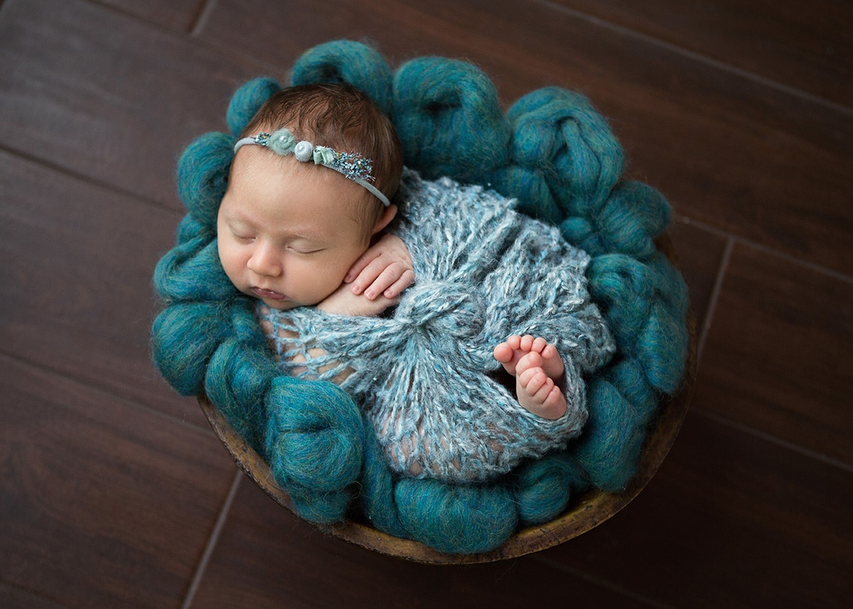 baby in bowl wrapped in teal captured by Jenn Brookover Newborn Photographer San Antonio