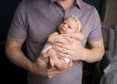A man holding a newborn baby in his arms.