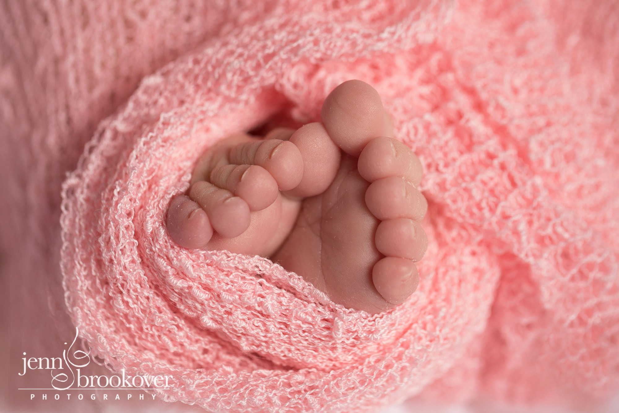 baby feet wrapped in pink close up by Jenn Brookover Photography taken during a newborn photo session in San Antonio
