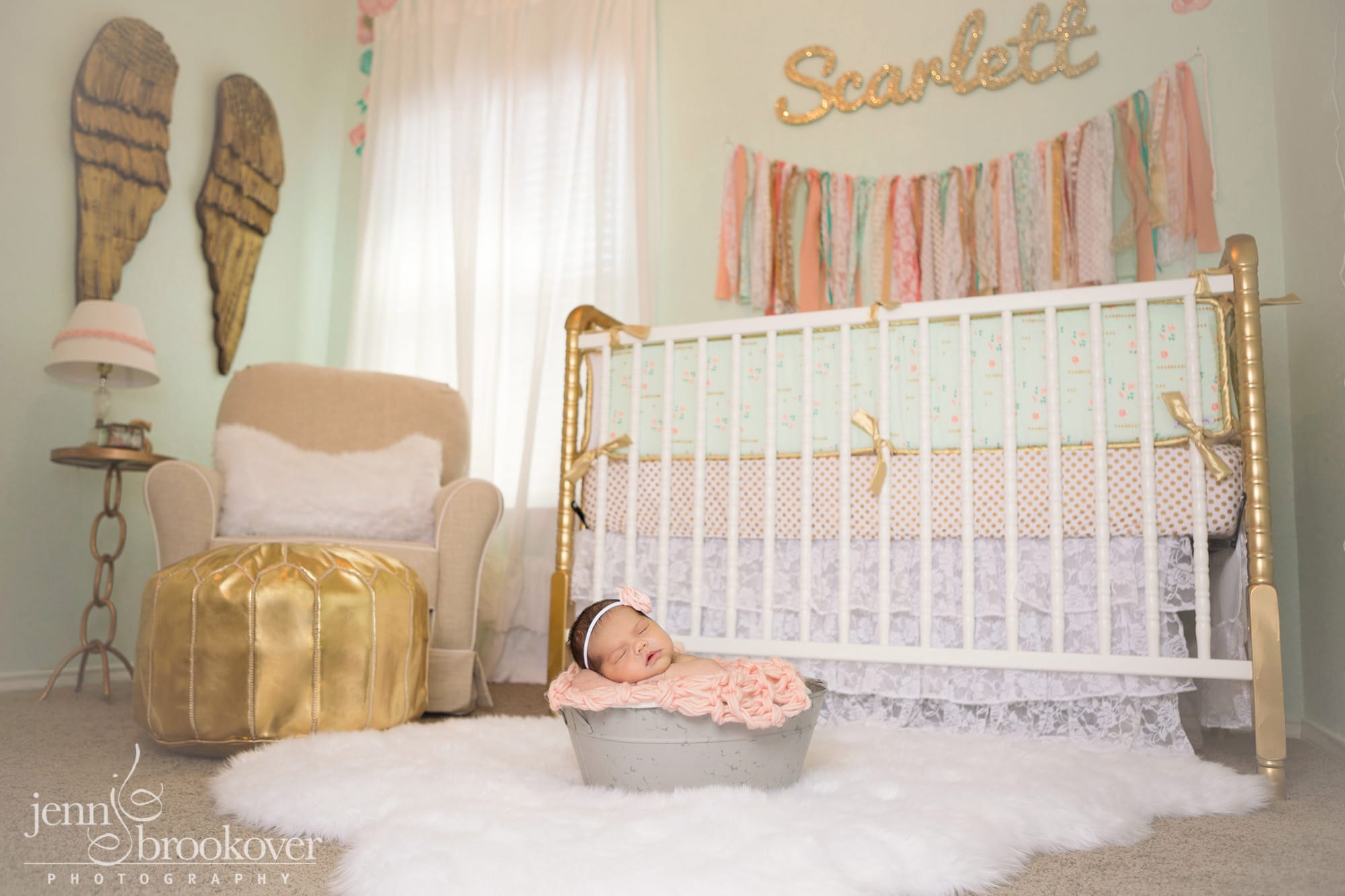 gorgeous peach, mint and gold nursery designed by Nursery Couture, newborn in a bucket sleeping during her photo session with Jenn Brookover in Texas