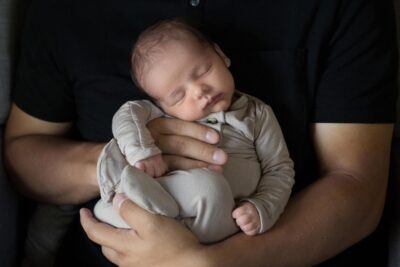 A man holding a baby in his arms.