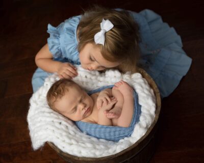 A baby boy and a baby girl in a basket.