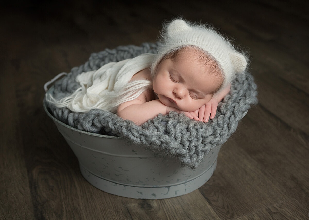 white bear fur bonnet newborn gray tub captured by Jenn Brookover Newborn Photographer San Antonio