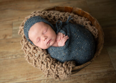 newborn baby in a bucket in San Antonio, TX during his newborn photo shoot